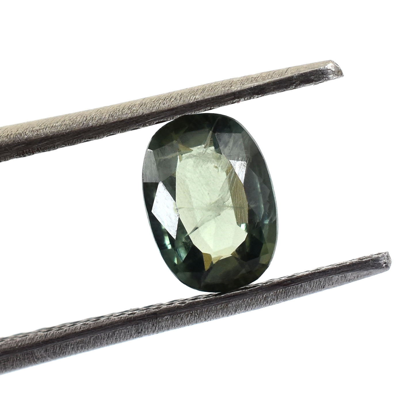 Oval-cut green gemstone held between tweezers.