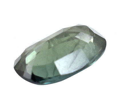 Faceted pale green gemstone with an oval shape.