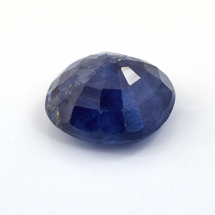 Faceted blue gemstone with a deep sapphire color.