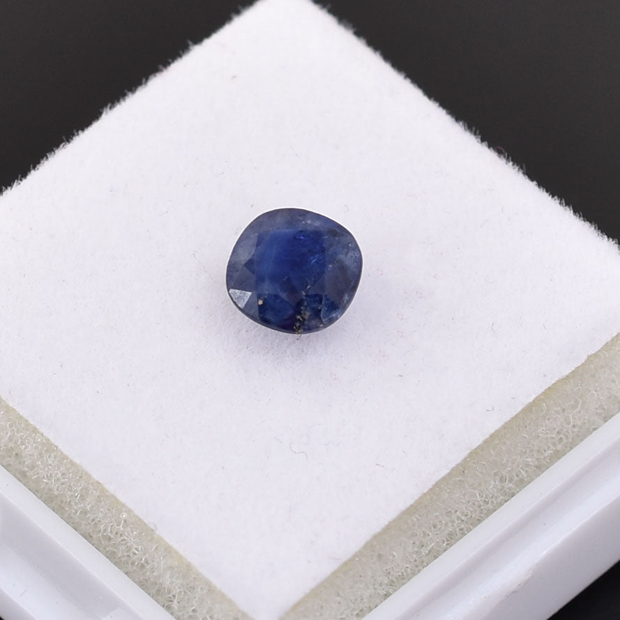 Deep blue sapphire gemstone with a cushion cut.