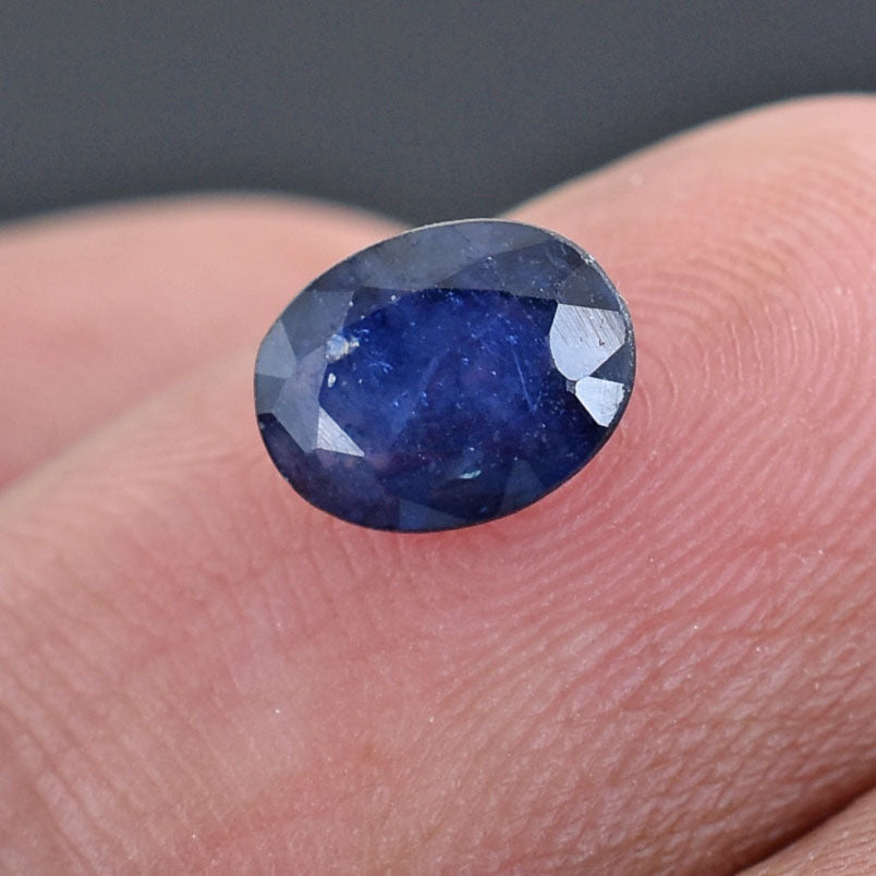 Deep blue oval-cut sapphire gemstone.