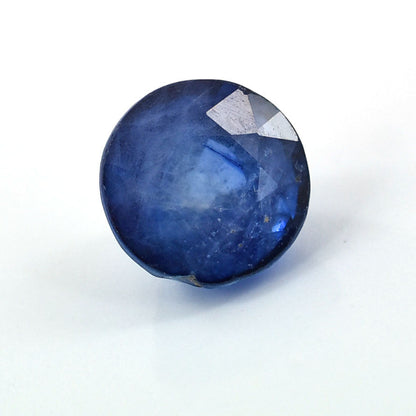 Deep blue sapphire gemstone with a faceted top.