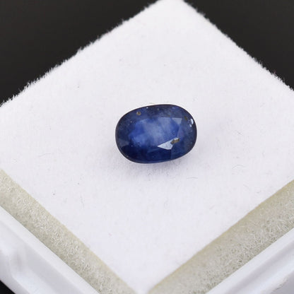 Oval-shaped blue gemstone, likely a sapphire.