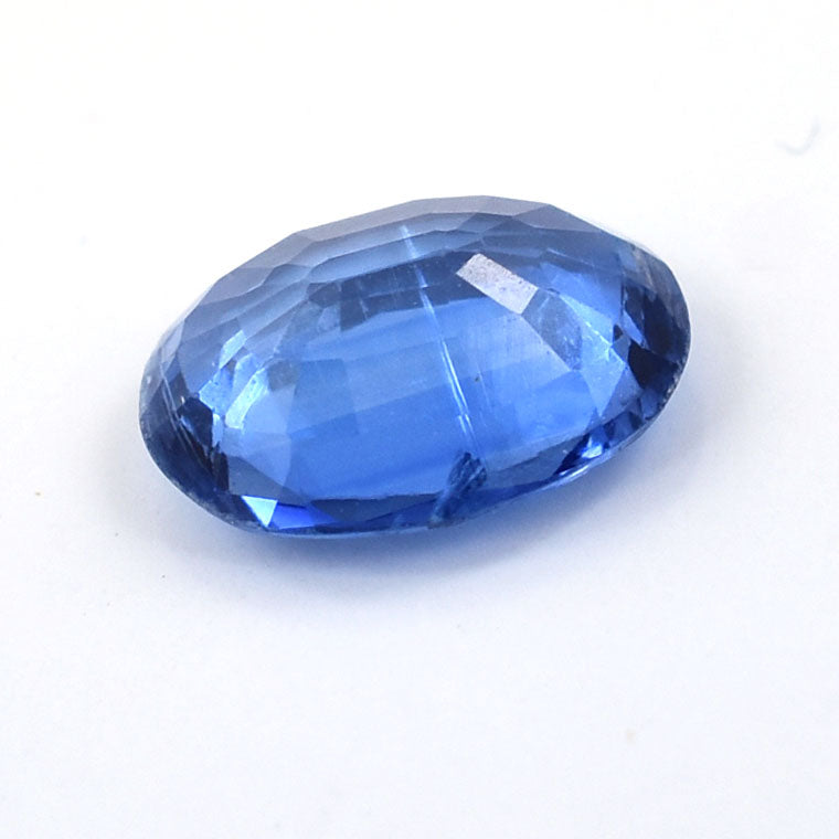 Faceted blue gemstone with an oval cut.