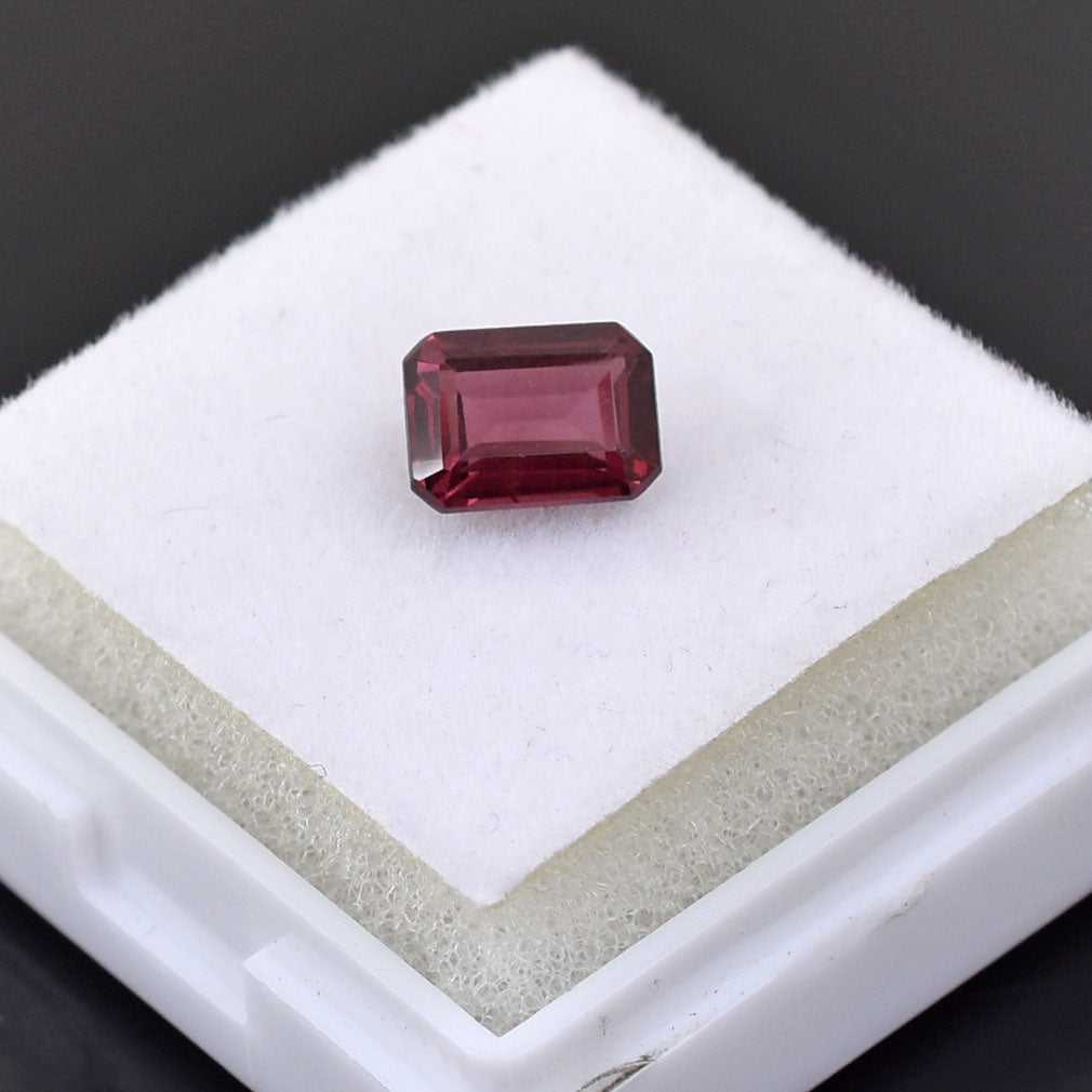 Rectangular-cut pink gemstone, likely a ruby or tourmaline.