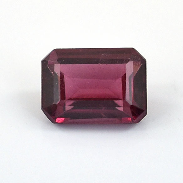 Emerald-cut deep pink gemstone, likely a tourmaline or rhodolite garnet.