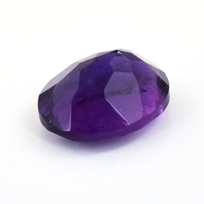 Faceted purple gemstone with a deep amethyst color.