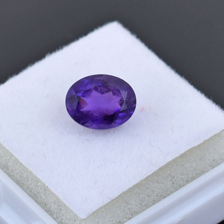 Oval-cut purple gemstone, likely an amethyst.