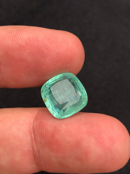 Square-cut emerald gemstone with a vibrant green color.