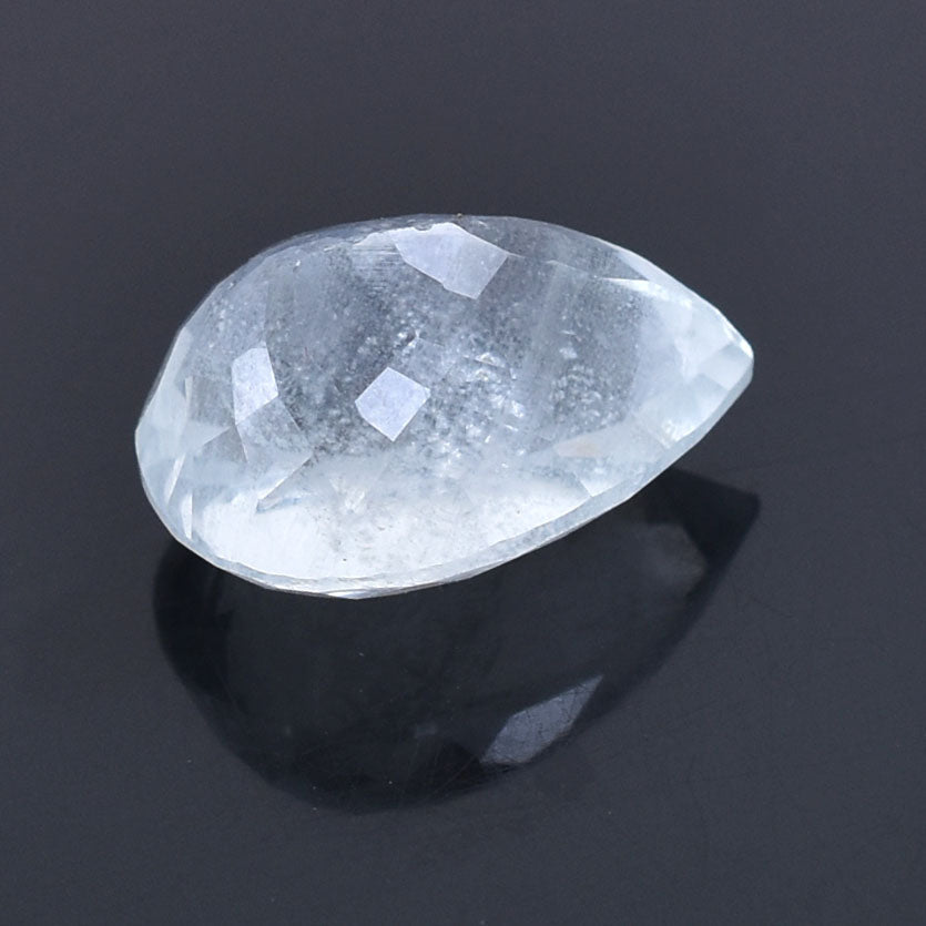 Teardrop-shaped, faceted clear gemstone or crystal with a reflective surface.