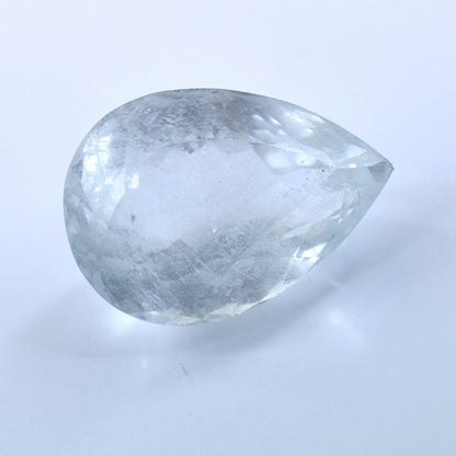 Pear-shaped, translucent gemstone or crystal with a cloudy appearance.