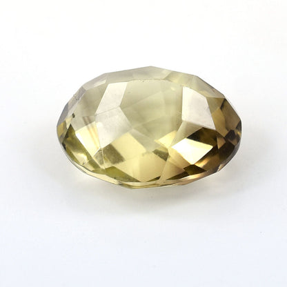 Faceted oval gemstone with a pale yellow-green color.