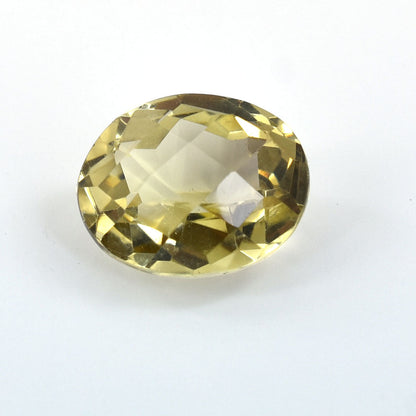 Oval-cut pale yellow gemstone with facets reflecting light.