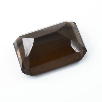 Rectangular-cut smoky quartz gemstone with faceted edges.