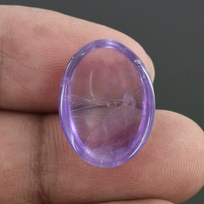 Purple translucent oval gemstone with internal inclusions.