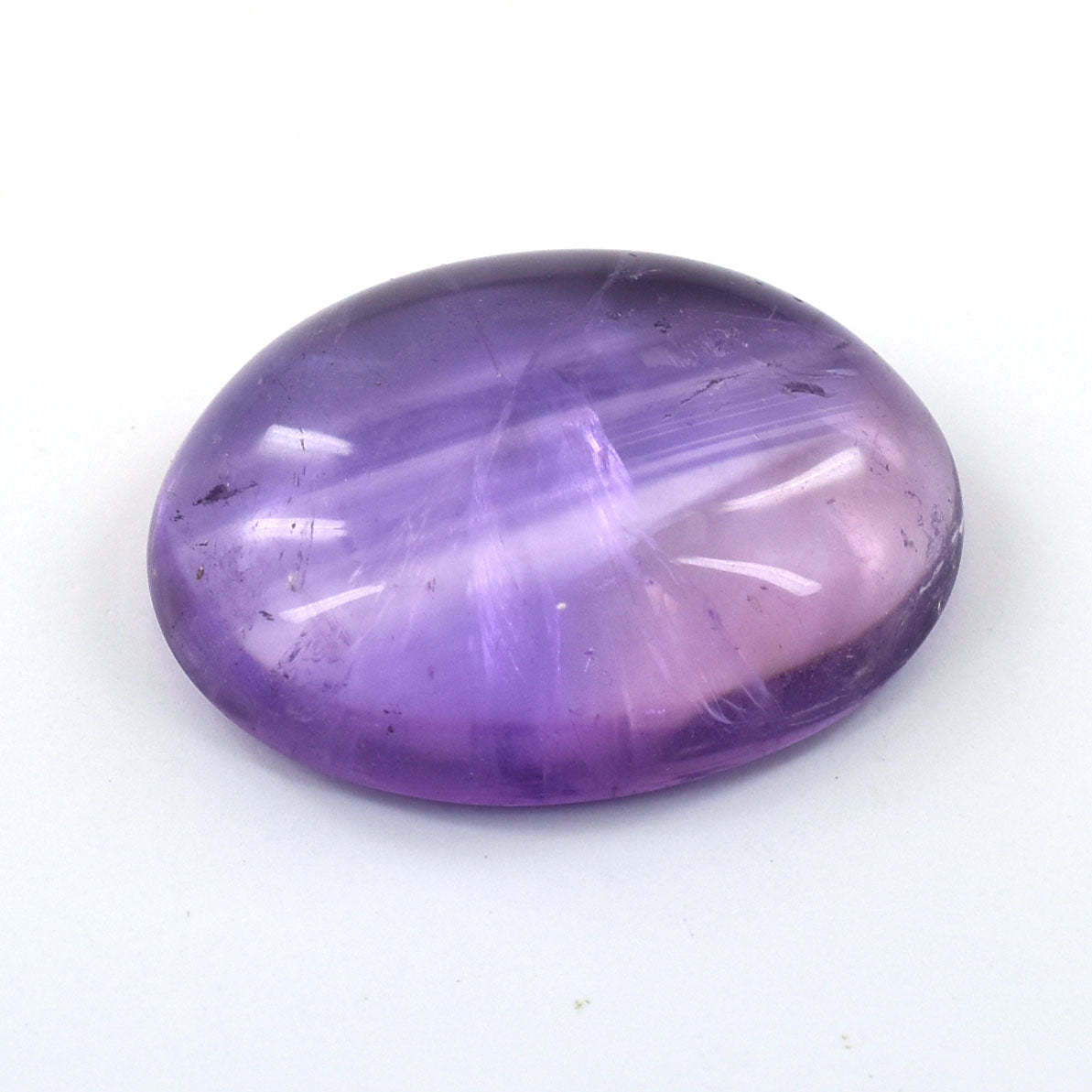 Polished oval amethyst gemstone with a smooth cabochon cut.