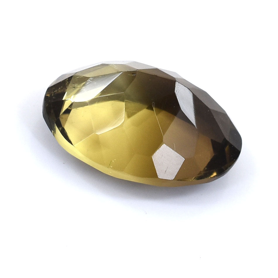 Faceted yellow-brown gemstone with a smooth, oval shape.