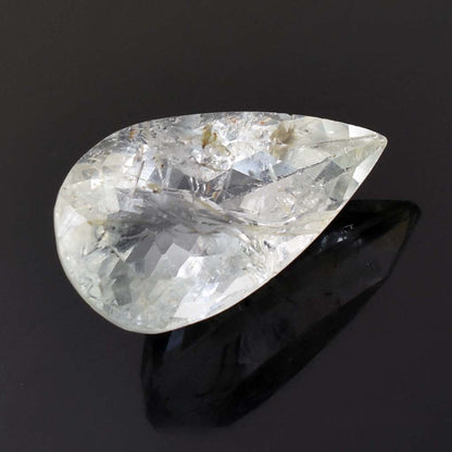 Teardrop-shaped clear gemstone with internal inclusions and facets.