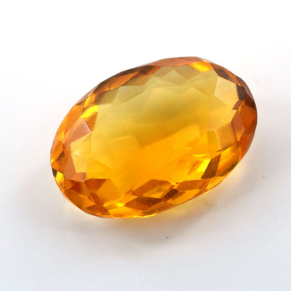 Faceted oval gemstone in a vibrant amber-yellow color.