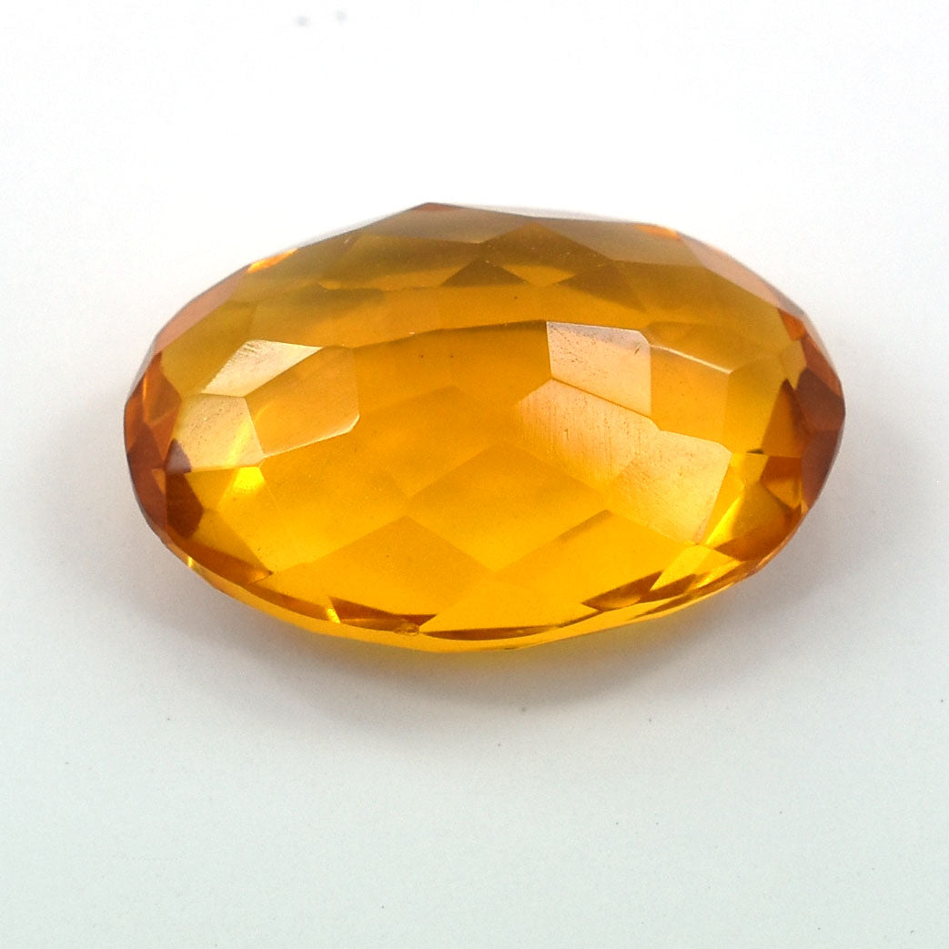 Faceted oval gemstone in a rich amber or citrine color.