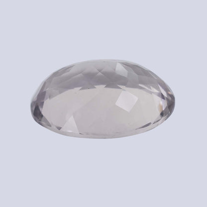 Oval-shaped, faceted clear gemstone or crystal.