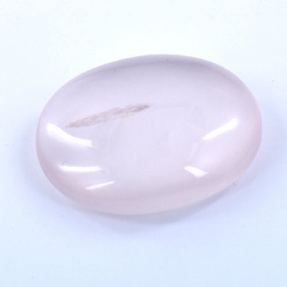 Smooth, oval-shaped pale pink gemstone or polished stone.