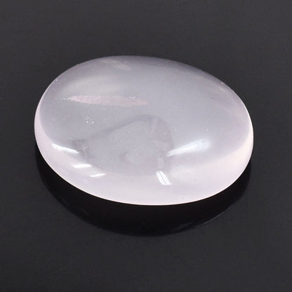 Smooth, oval-shaped white gemstone or polished stone with a lustrous surface.