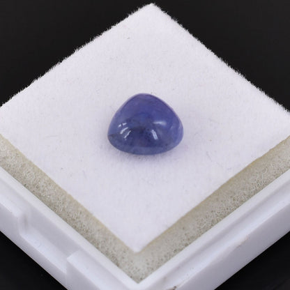 Smooth, dome-shaped purple gemstone or cabochon.