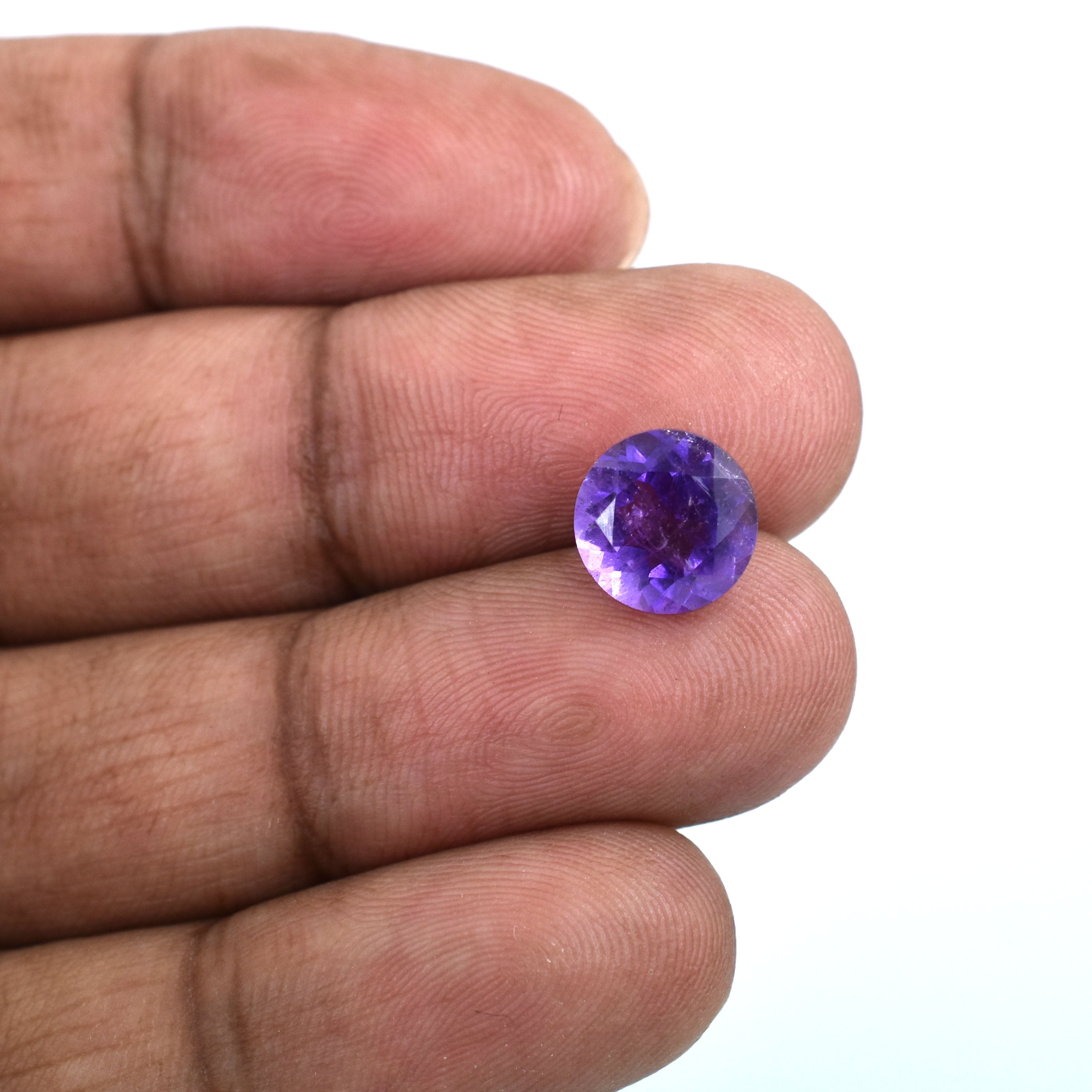 Round-cut purple gemstone, likely an amethyst.