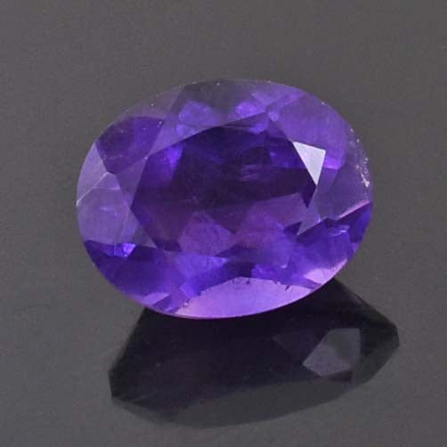 Faceted oval-cut purple gemstone, likely an amethyst.