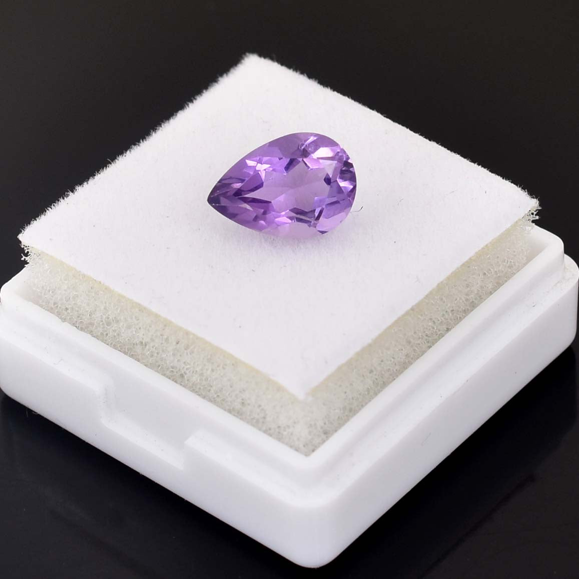 Pear-shaped purple gemstone, likely an amethyst.