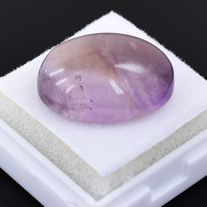 Oval-shaped amethyst gemstone with a soft purple hue.