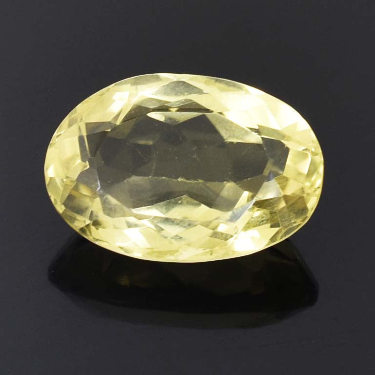 Oval-cut pale yellow gemstone with facets reflecting light.