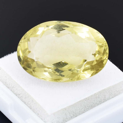 Oval-cut pale yellow gemstone, likely a citrine or yellow sapphire.