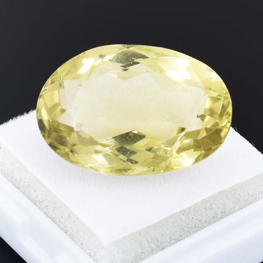 Oval-cut pale yellow gemstone, likely a citrine or yellow sapphire.