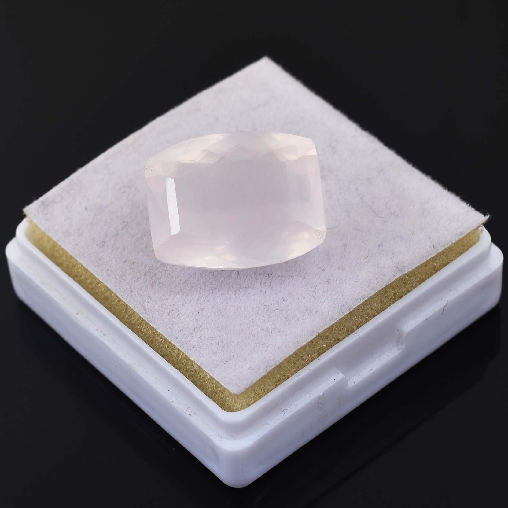 Translucent pink gemstone or crystal with a cushion cut shape.