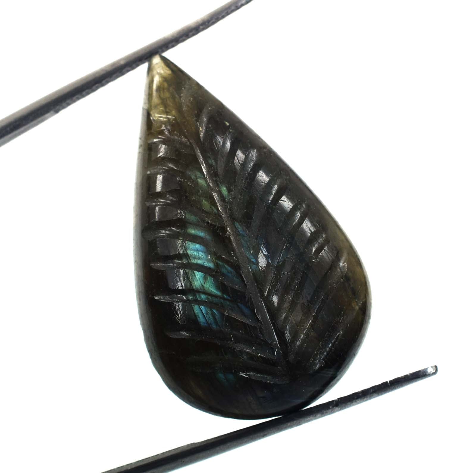 Carved leaf-shaped gemstone with iridescent blue-green flashes.