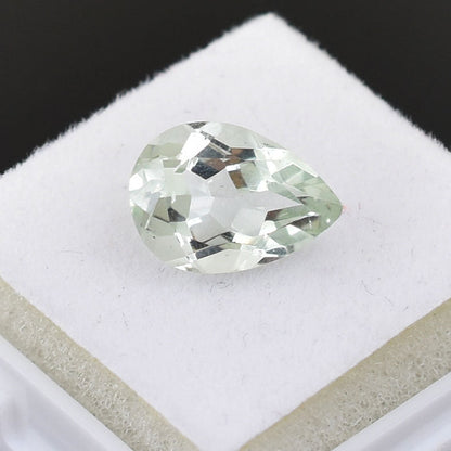 Pear-shaped diamond or gemstone with a pale green tint.