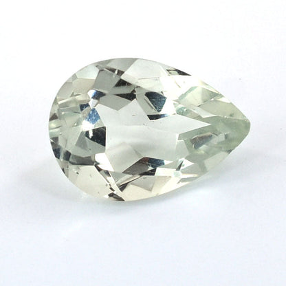 Pear-shaped, faceted gemstone with a pale green hue.