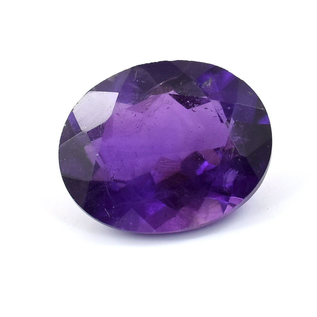 Oval-cut purple gemstone with facets reflecting light.