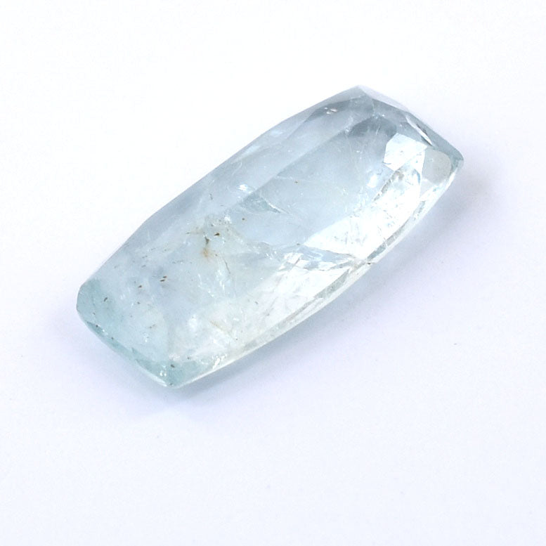 Elongated, pale blue gemstone or crystal with a faceted surface.