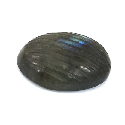 Smooth, oval-shaped labradorite gemstone with dark gray coloration and blue iridescent flashes.