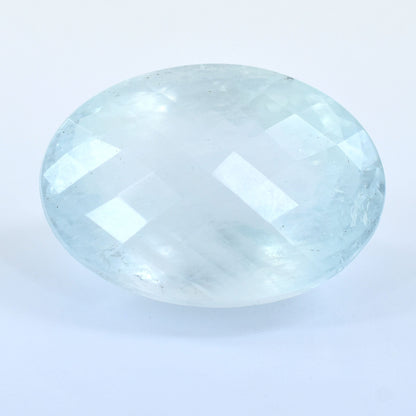 Oval-shaped, pale blue gemstone with faceted surfaces.