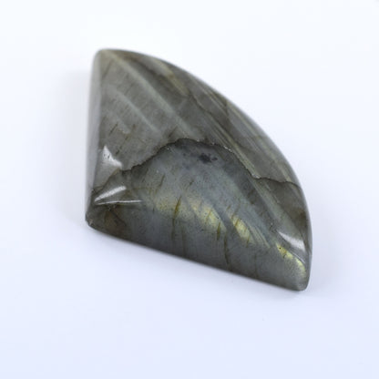 Polished gray gemstone or cabochon with a triangular shape and subtle iridescent sheen.