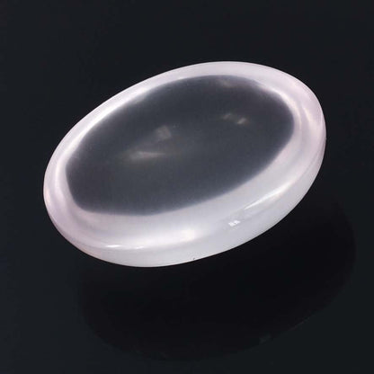 Oval-shaped, white contact lens with a slightly concave surface.