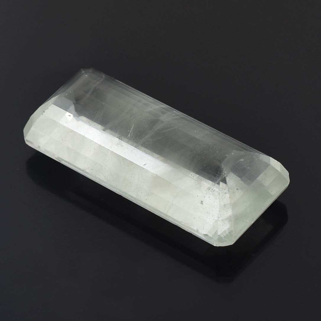 Translucent, rectangular crystal or mineral specimen with a smooth, polished surface.