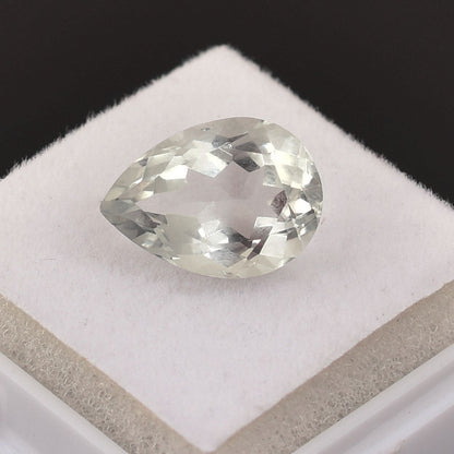 Pear-shaped, colorless gemstone with faceted cuts.