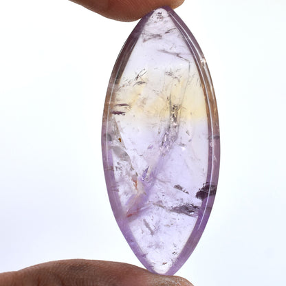 Oval-shaped gemstone with purple and yellow hues and internal inclusions.