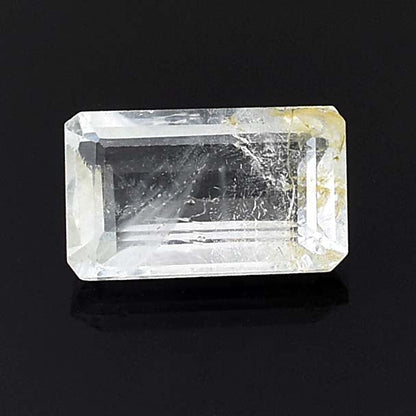 Rectangular cut gemstone or crystal with visible inclusions and imperfections.