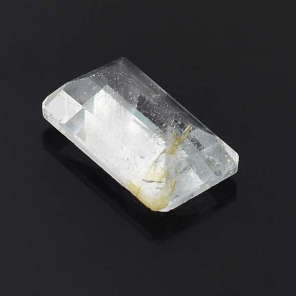 Clear crystal or gemstone with a rectangular faceted shape.